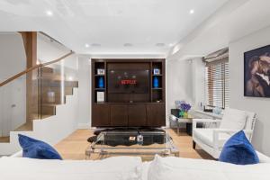 a living room with a tv and a couch at St James Park and Westminster Luxury Suite in London