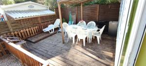 a table and chairs on a wooden deck at REGENCY HOLIDAY Tour Opérateur dans Camping 5 étoiles Frejus, Cote d'Azur in Fréjus