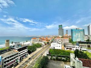 a view of a city with the ocean and buildings at Colombo Emperor Residencies in Colombo