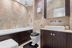 a bathroom with a toilet and a sink and a shower at St James Park and Westminster Luxury Suite in London