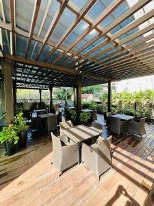a patio with tables and chairs under a pergola at Colombo Emperor Residencies in Colombo