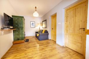 a living room with a couch and a wooden door at Boglárka Vendégház in Vasvár