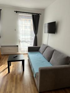 a living room with a couch and a table at Apartman pri vleku in Telgárt