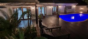 a house with a swimming pool at night at Leopard Tree Lodge in St Lucia