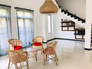 a dining room with a glass table and chairs at Villa Ocean Breeze in Ahangama +69 photos