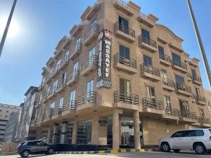 a building with cars parked in front of it at Massayef Al Khobar 2 in Al Khobar