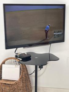 a television screen with a picture of a man playing golf at Superb Penthouse in Central Fuengirola in Fuengirola