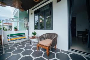 a chair sitting on a porch with a table at Marina Hoian Villa in Hoi An