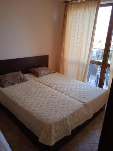 A bed or beds in a room at South Beach Nesebar Apartment Larisa