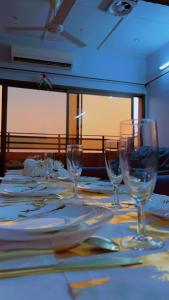 a table with wine glasses and plates on it at AG HOTEL Ouaga in Ouagadougou