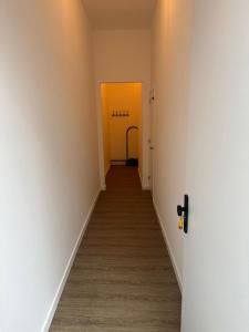 a hallway with two yellow doors and a wooden floor at luxe pas gerenoveerd monumentaal appartement in Maastricht