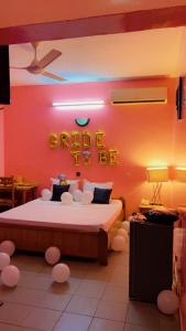 a bedroom with a bed with a sign that reads ride me at AG HOTEL Ouaga in Ouagadougou