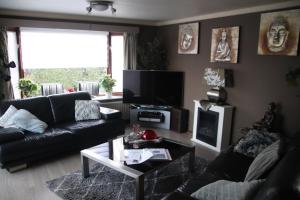 a living room with a couch and a coffee table at Veluwe Park Reewold Chalet Talisman in Putten