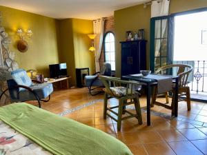 a living room with a table and chairs at Competa Suites in Cómpeta