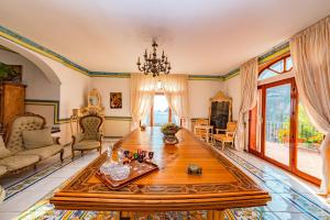 a living room with a table and a large window at Villa Costa degli Dei in Furore