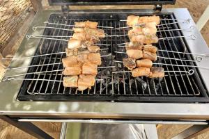 a bunch of food cooking on a grill at Bungalow Ramena beach Antsiranana in Andjamen