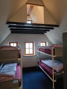a room with two bunk beds in a attic at Viktoria HOSTEL in Antwerp