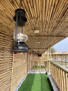 a wooden building with a green floor and a light at Gopika Resort in Vrindāvan