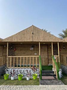 a wooden house with plants in front of it at Gopika Resort in Vrindāvan