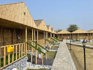 a row of wooden buildings with a playground at Gopika Resort in Vrindāvan