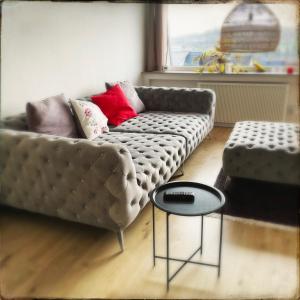 a living room with a couch and a table at Schöne Penthousewohnung mit Weitblick in Arnsberg