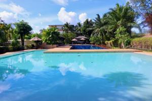 a large swimming pool with blue water at 3BR Family Home in Laguna — 100m walk from beach in Phuket Town