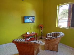 a living room with two chairs and a table at Magical Fharhana House in Malindi