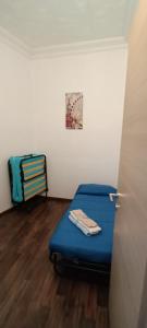 a small room with a bed and a chair at Casa vacanze Paglino in Ventimiglia