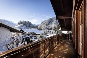 a balcony with a view of a snow covered mountain at Ferienwohnungen Oberstdorf Schwartges in Oberstdorf