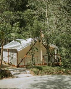 a large tent in the middle of a forest at Glamping tent in Pelaga Eco Park in Patjung