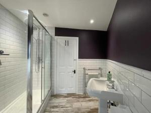 a white bathroom with a sink and a shower at Peak District Stay Stylish for 2 Pass the Keys in New Mills