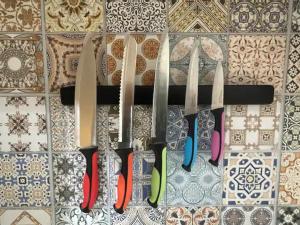 a group of knives hanging on a wall at Peak District Stay Stylish for 2 Pass the Keys in New Mills