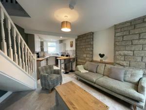 a living room with a couch and a table at Peak District Stay Stylish for 2 Pass the Keys in New Mills