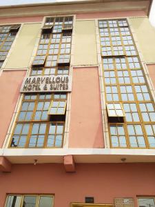 a building with a sign for mayilours hotel and suites at MARVELLOUS hotel in Lagos