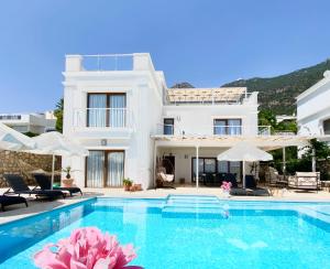 a villa with a swimming pool in front of a house at Villa Sapphire in Kalkan