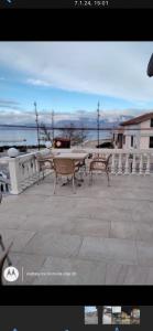 a picture of a patio with a table and benches at HOTEL Casa Vacanze SHIROKE in Shkodër