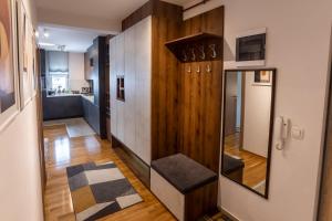 a living room with a hallway with a bench in it at Apartman AuRa in Arandjelovac