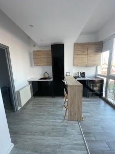 a kitchen with a wooden table in a room at Marisah Residence #2 in Otopeni +4 photos