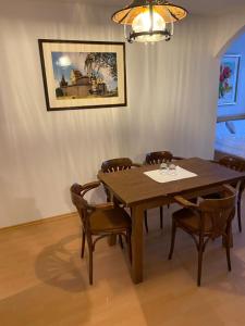a dining room with a wooden table and chairs at Schlossschänke Friedenfels in Friedenfels +34 photos