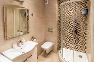 a bathroom with a toilet and a shower and a sink at Apartman AuRa in Arandjelovac