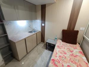 a small bathroom with a bed and a sink at snooze 3 in Panchkula