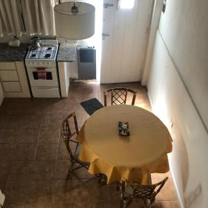 a kitchen with a table and chairs in a room at Dto tres personas mas elegido wifi libre-acepta mascotas-parrilla-piscina-reposeras-terraza solarium in Mar del Plata