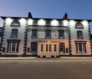 a large brick building with a sign on it at THE LORD NELSON HOTEL in Pembrokeshire