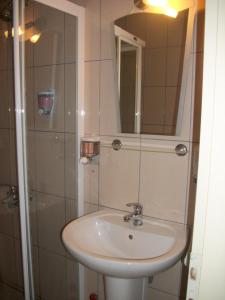 a bathroom with a sink and a shower at Kosar Hotel in Denizli