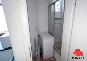 a small white refrigerator in a room with a window at Ganze Monteurwohnung zum Entspannen in Bremen
