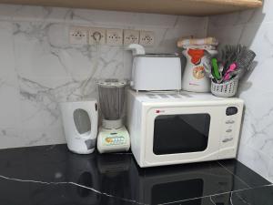 a kitchen with a microwave and a blender on a counter at Marrakech in Marrakech