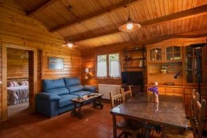 a living room with a blue couch and a table at Apartamentos El Cueto in Oviñana