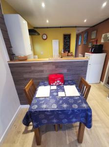 a kitchen with a table with a red pillow on it at The Annex in Cemaes Bay
