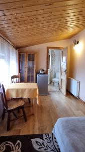 a room with a table and a bathroom with a toilet at Mountain House in Ustrzyki Dolne