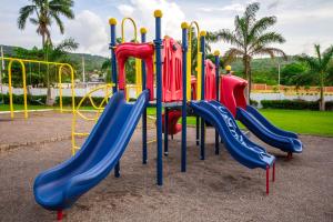 a playground with a slide in a park at Ocho Rios Drax hall Manor 3 Bed sleeps 7 in Saint Annʼs Bay